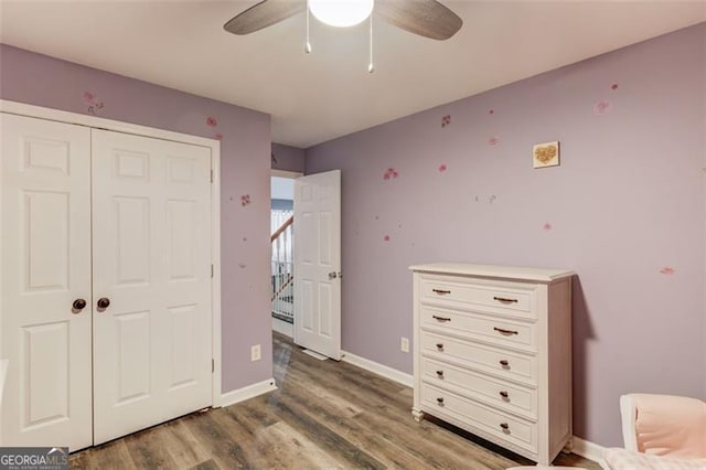 bedroom featuring a closet, ceiling fan, and dark hardwood / wood-style floors