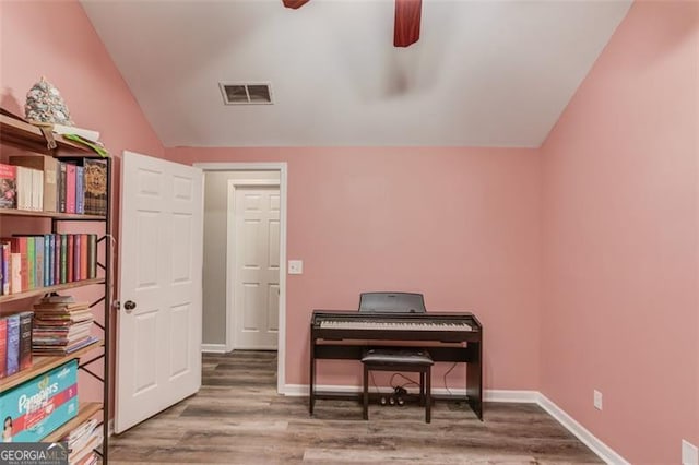 miscellaneous room featuring hardwood / wood-style flooring, vaulted ceiling, and ceiling fan