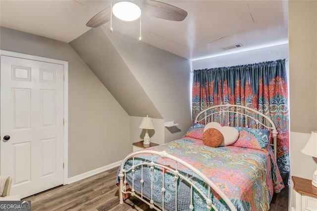 bedroom with ceiling fan, wood-type flooring, and lofted ceiling