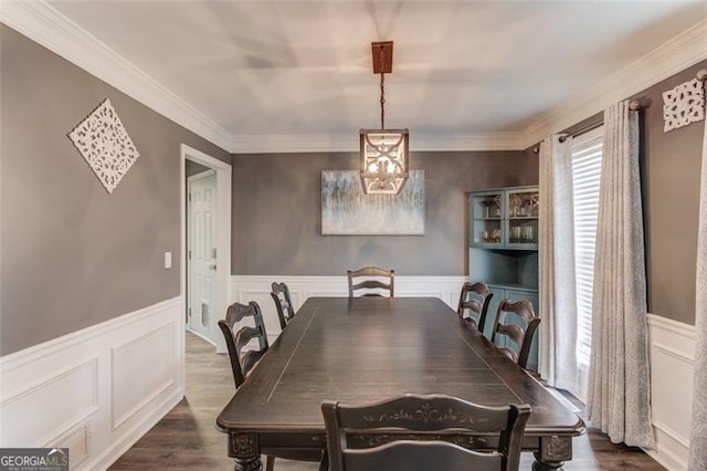 dining space with crown molding and dark hardwood / wood-style flooring