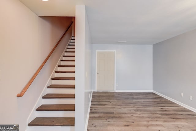 stairs featuring wood-type flooring