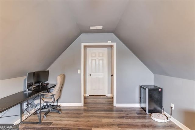 office with dark hardwood / wood-style flooring and lofted ceiling