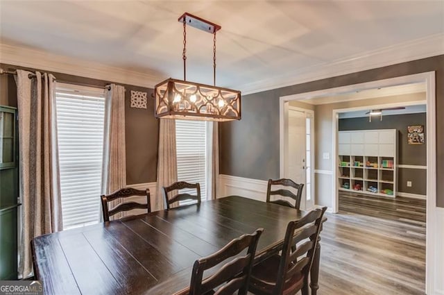 dining room with hardwood / wood-style floors and crown molding