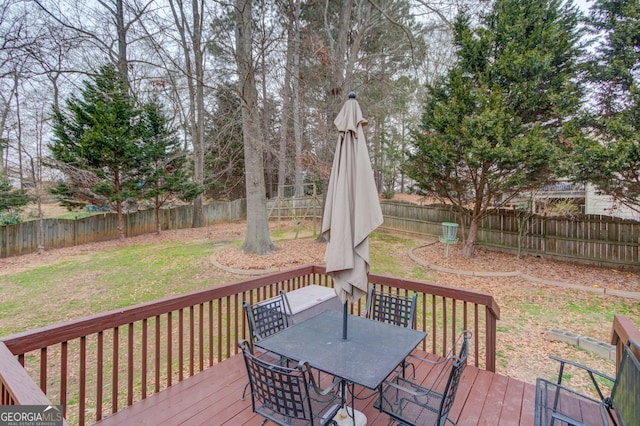 wooden terrace with a lawn