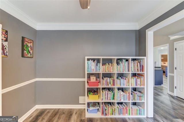 playroom with ornamental molding and hardwood / wood-style floors