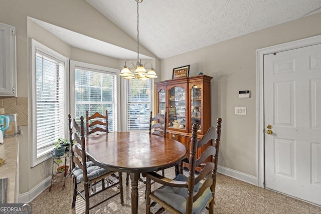 dining area featuring a textured ceiling, an inviting chandelier, and lofted ceiling