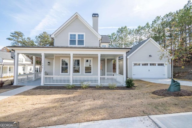 country-style home with an outdoor structure, a porch, and a garage