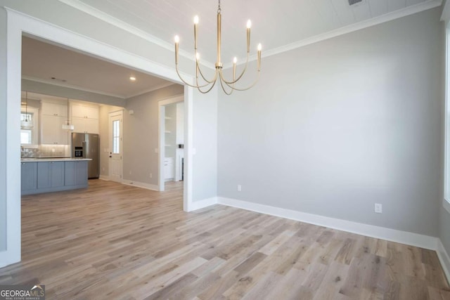 interior space with crown molding, light hardwood / wood-style floors, and a notable chandelier