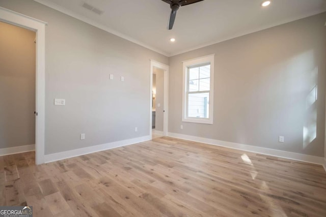 unfurnished room featuring ceiling fan, light wood-type flooring, and ornamental molding