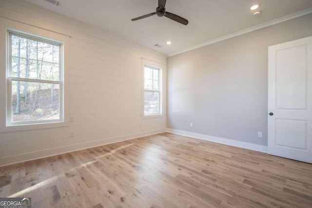 spare room featuring light hardwood / wood-style floors, ceiling fan, and ornamental molding