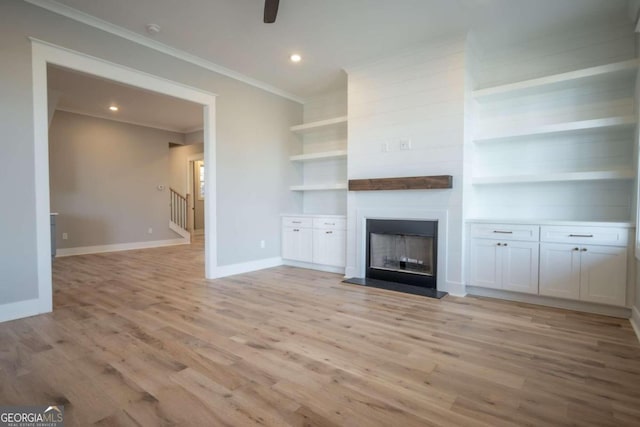 unfurnished living room featuring crown molding, ceiling fan, and light wood-type flooring