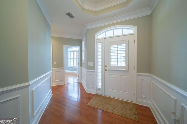 entrance foyer with light hardwood / wood-style flooring and ornamental molding