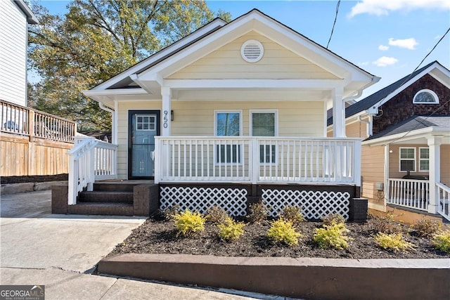 bungalow-style home featuring covered porch and central AC