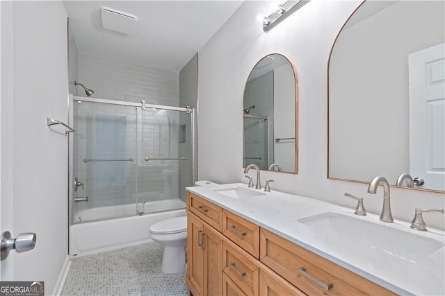 full bathroom with tile patterned flooring, vanity, toilet, and shower / bath combination with glass door