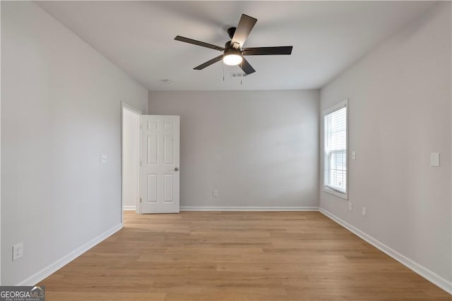 empty room with ceiling fan and light wood-type flooring