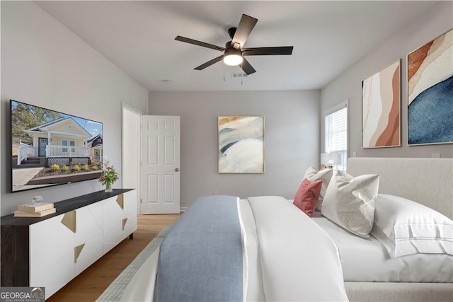 bedroom with hardwood / wood-style floors and ceiling fan