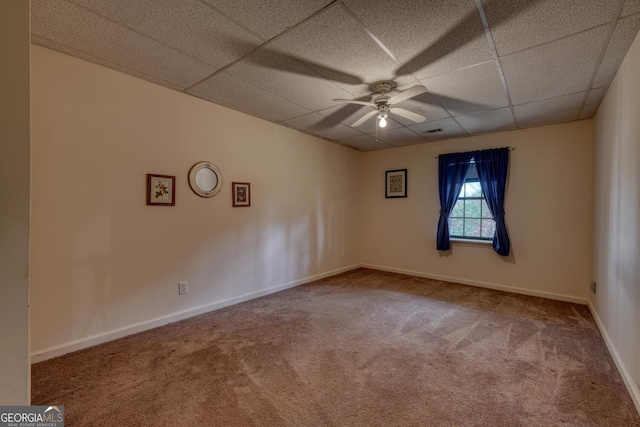 unfurnished room with carpet, a drop ceiling, and ceiling fan