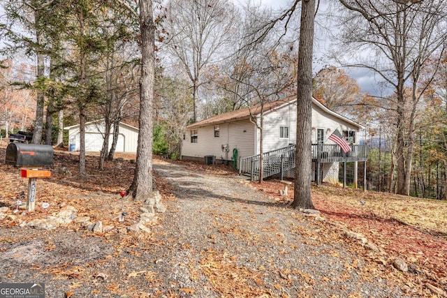 view of property exterior with central AC unit and a deck