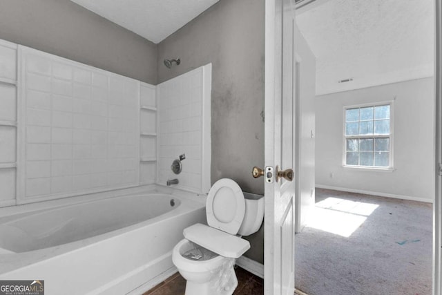 bathroom featuring a textured ceiling,  shower combination, and toilet