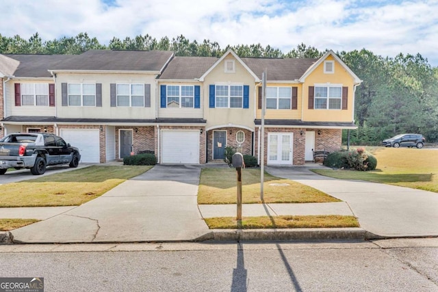 multi unit property with a front lawn, a garage, and french doors