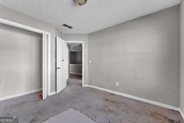 unfurnished bedroom with a textured ceiling