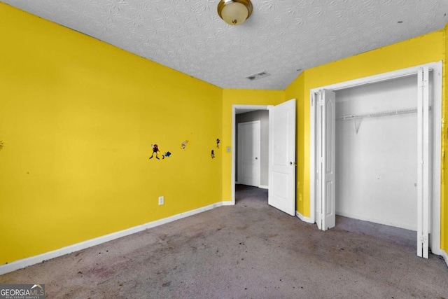 unfurnished bedroom with carpet flooring, a closet, and a textured ceiling