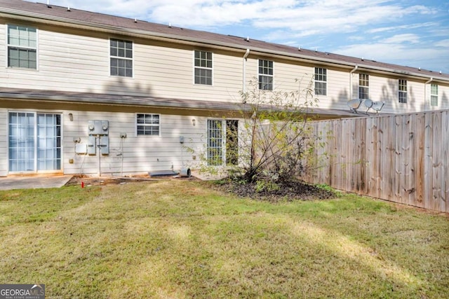 rear view of property featuring a yard