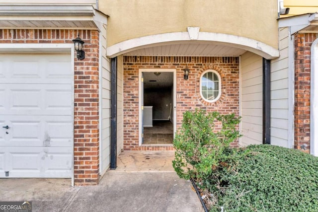 doorway to property with a garage