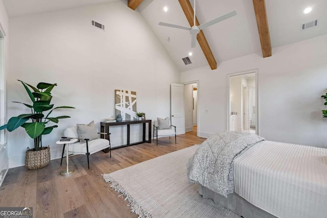 bedroom featuring high vaulted ceiling, beamed ceiling, and light wood-type flooring