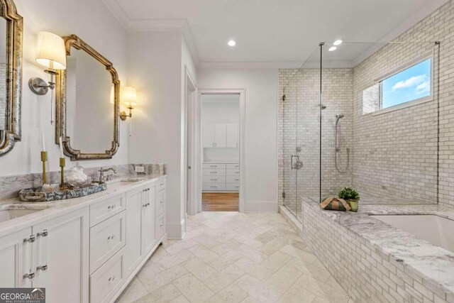 bathroom with vanity, ornamental molding, and shower with separate bathtub