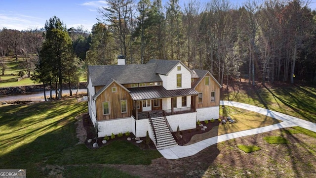 view of front of house featuring covered porch and a front yard