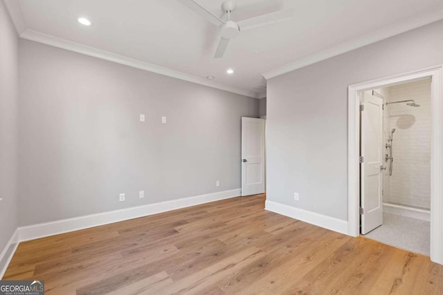 unfurnished bedroom featuring light hardwood / wood-style floors, connected bathroom, crown molding, and ceiling fan