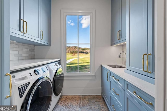 laundry area with sink, separate washer and dryer, and cabinets