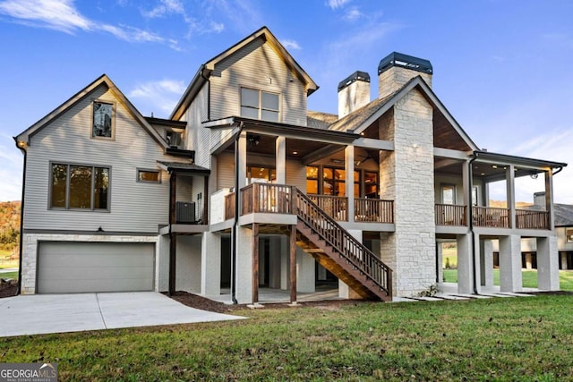 rear view of property with a garage, a yard, a patio, and central AC