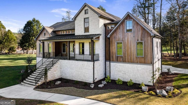 modern inspired farmhouse with a front yard and a porch