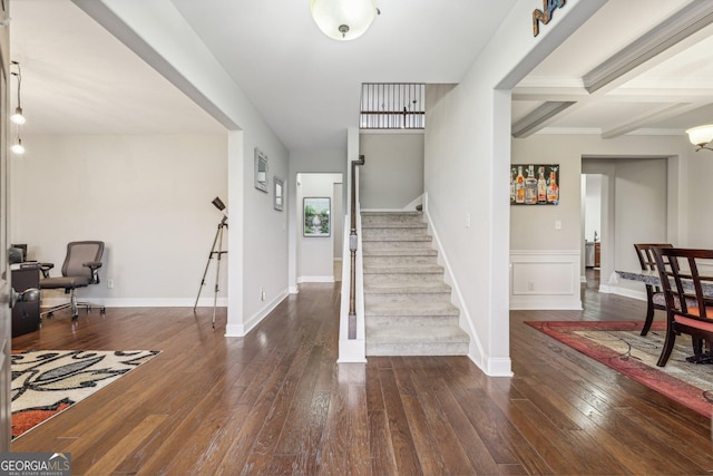 foyer entrance featuring beam ceiling, coffered ceiling, and dark hardwood / wood-style floors