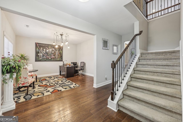 foyer featuring a chandelier and dark wood-type flooring