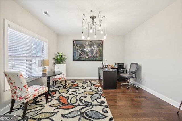 office area with a notable chandelier and dark hardwood / wood-style floors