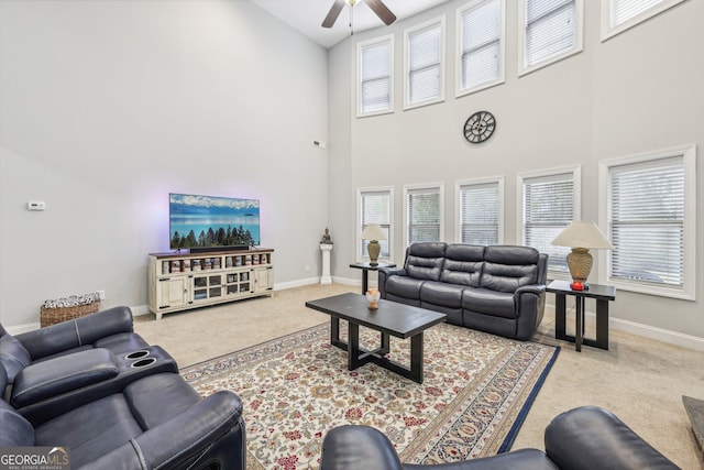 living room with carpet floors, ceiling fan, and high vaulted ceiling