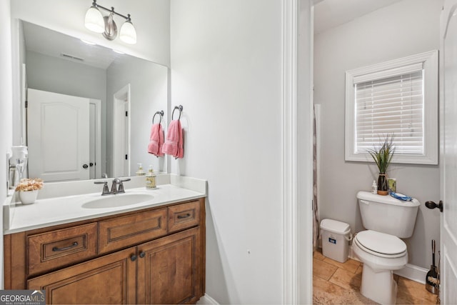 bathroom with vanity and toilet