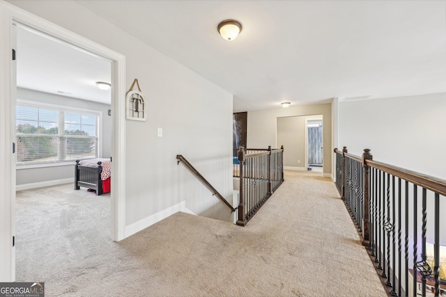 hallway featuring light colored carpet