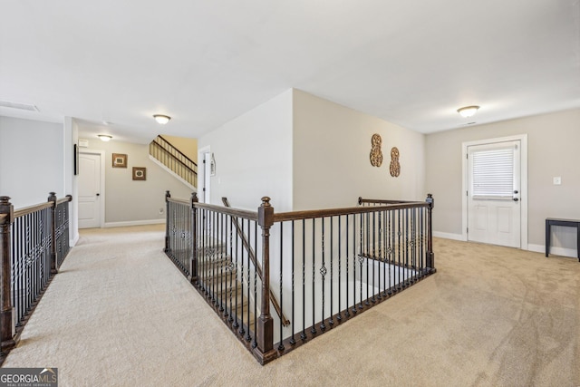 hallway featuring light carpet