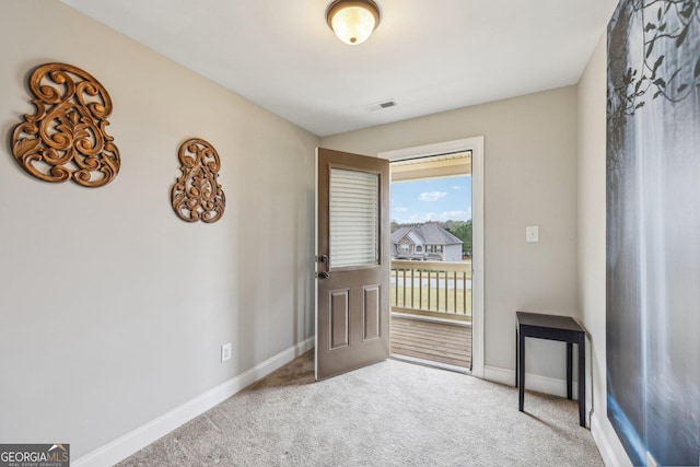 doorway to outside with carpet floors