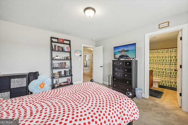 bedroom featuring ensuite bath and light colored carpet