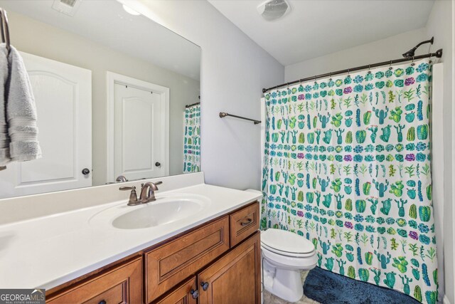 bathroom featuring vanity and toilet