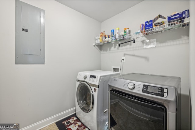 laundry room with electric panel and washing machine and clothes dryer