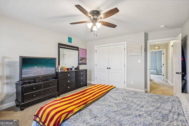 carpeted bedroom with a closet and ceiling fan