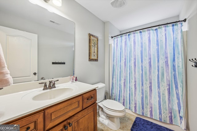 bathroom featuring tile patterned flooring, a shower with curtain, vanity, and toilet