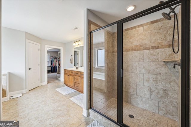 bathroom featuring vanity and a shower with shower door