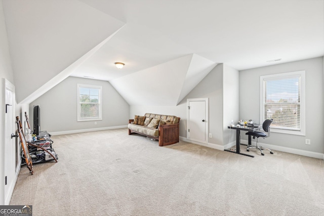 sitting room with light carpet and vaulted ceiling